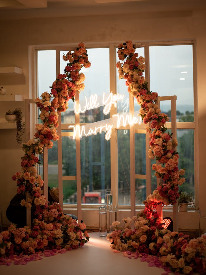 services-03 Floral arch with Will You Marry Me neon sign, ideal for romantic proposals.