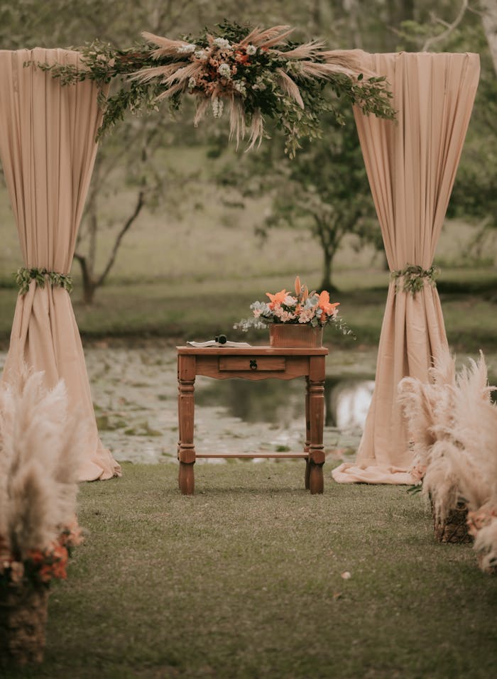 gallery-6 Beautiful rustic wedding altar setup by a pond with natural decorations.